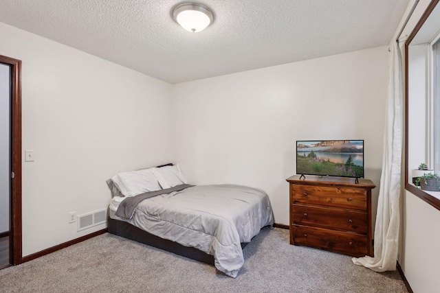 bedroom featuring baseboards, visible vents, and carpet floors