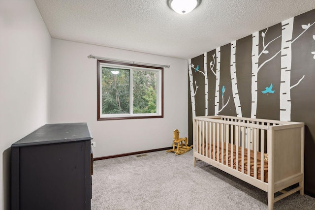 unfurnished bedroom with carpet flooring, a textured ceiling, and baseboards