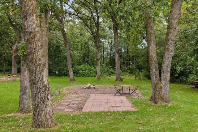 view of yard featuring an outdoor fire pit and a patio area