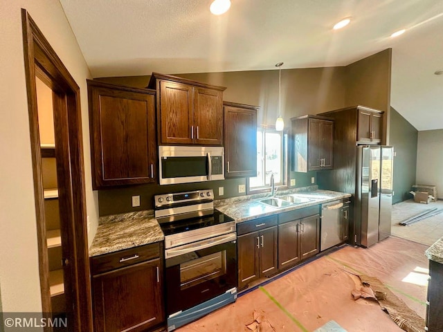 kitchen with a sink, stainless steel appliances, lofted ceiling, and dark brown cabinets