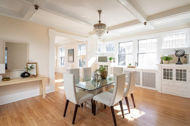 dining area with a chandelier, beamed ceiling, coffered ceiling, and light wood-type flooring