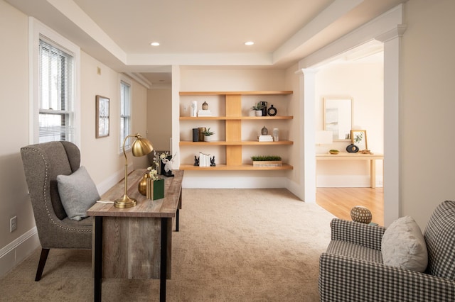 office area featuring built in shelves, baseboards, carpet floors, recessed lighting, and a raised ceiling