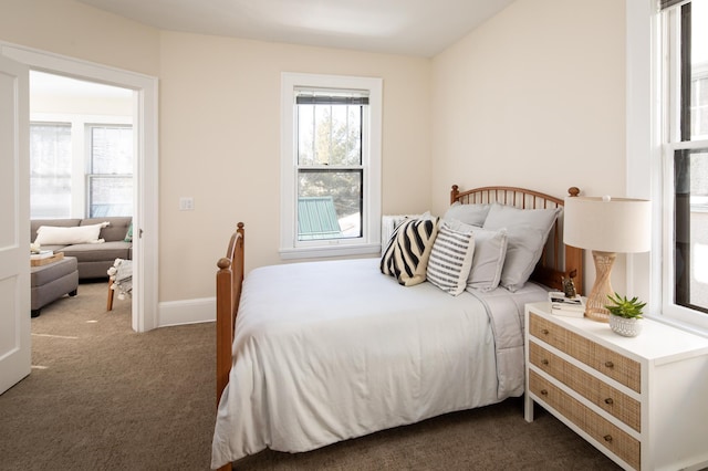 carpeted bedroom featuring baseboards