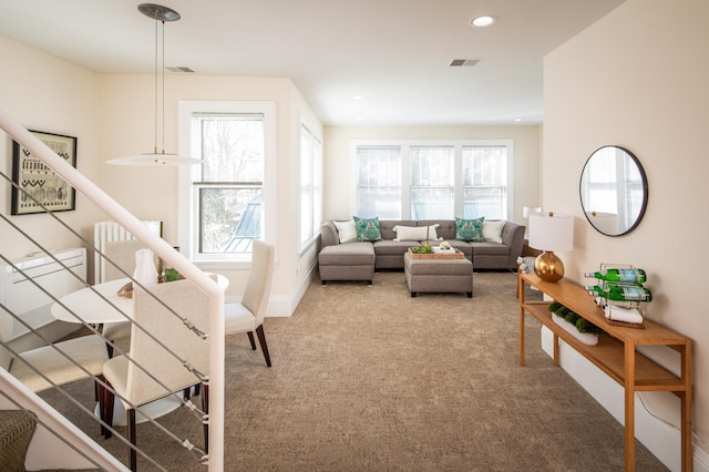 carpeted living area with recessed lighting, visible vents, plenty of natural light, and stairway