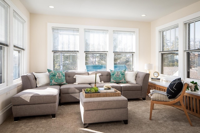 living area featuring recessed lighting and light colored carpet