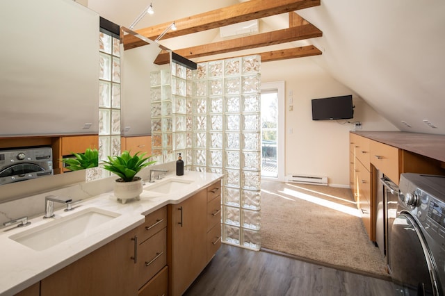 interior space with lofted ceiling with beams, wood finished floors, baseboard heating, and a sink