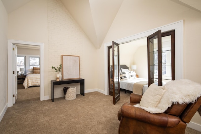 bedroom with carpet flooring, french doors, and high vaulted ceiling