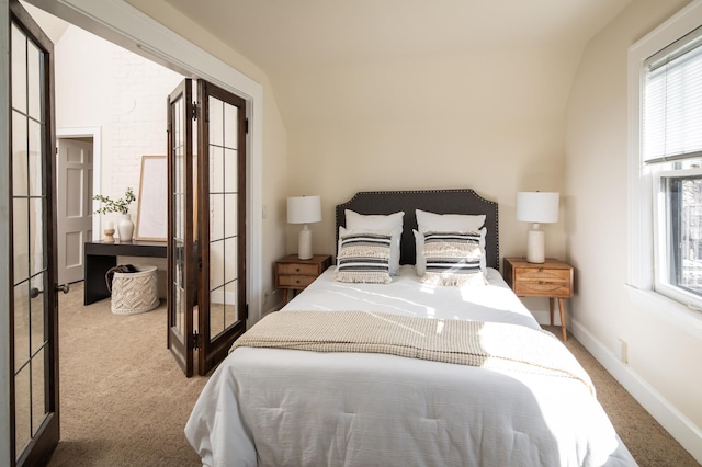 carpeted bedroom featuring french doors and baseboards