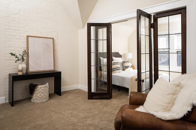 sitting room with lofted ceiling, french doors, baseboards, and carpet floors