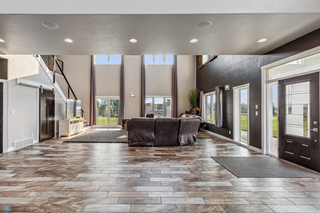 living room with visible vents, recessed lighting, and wood finish floors