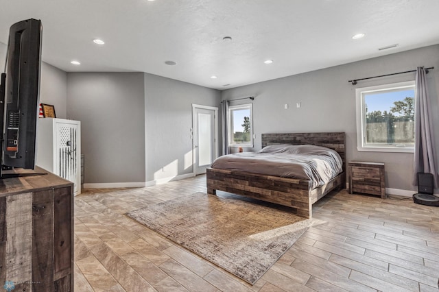 bedroom with access to exterior, multiple windows, recessed lighting, and baseboards