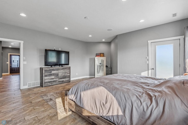 bedroom with visible vents, recessed lighting, baseboards, and wood finished floors