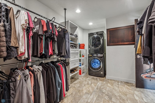 spacious closet with stacked washer and clothes dryer