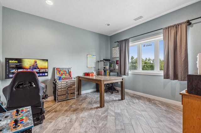 office with visible vents, baseboards, and wood finished floors