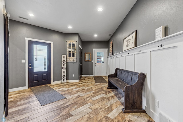 foyer featuring visible vents, recessed lighting, and light wood-style floors