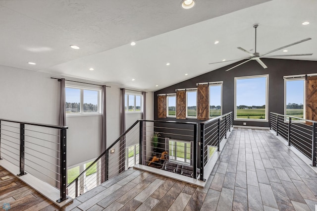 corridor featuring vaulted ceiling, recessed lighting, an upstairs landing, and wood tiled floor