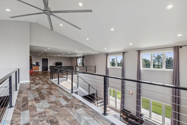 hall featuring recessed lighting, an upstairs landing, baseboards, and high vaulted ceiling