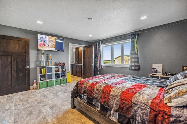 bedroom featuring recessed lighting and a textured ceiling