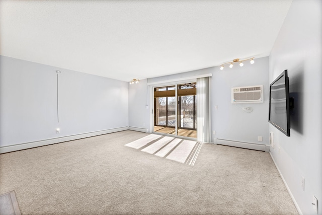 carpeted spare room featuring a baseboard heating unit, baseboards, and an AC wall unit