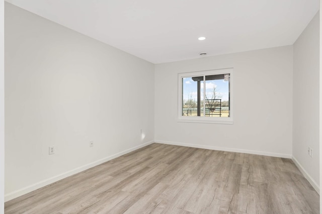 unfurnished room featuring recessed lighting, baseboards, and light wood-style floors