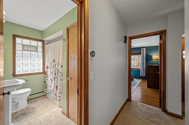 full bathroom with a baseboard heating unit, baseboards, toilet, and a shower with curtain