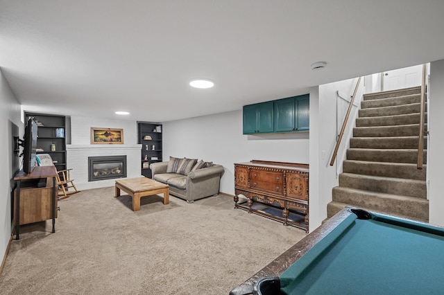 living room with built in features, stairway, light colored carpet, and a fireplace