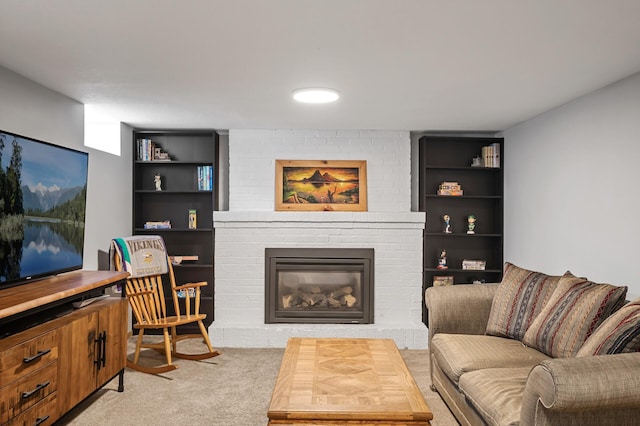 living area with built in features, light colored carpet, and a brick fireplace