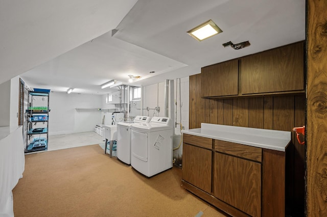 laundry area with a sink, cabinet space, and separate washer and dryer