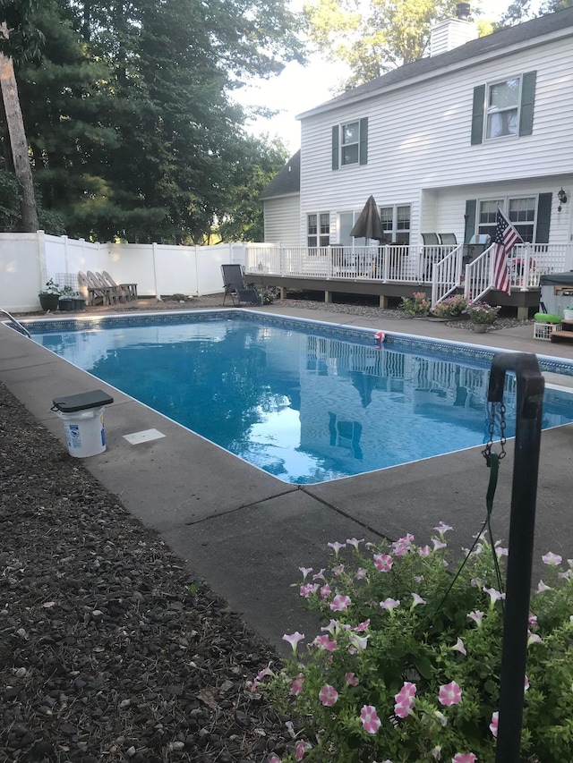 view of pool featuring a fenced in pool, a wooden deck, and a fenced backyard