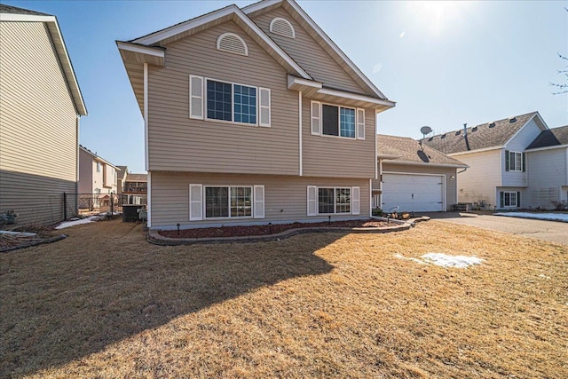 exterior space with a garage, a lawn, and fence