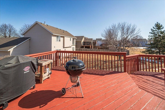 deck with fence, a residential view, and grilling area