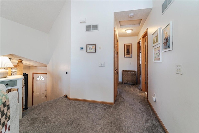 corridor featuring visible vents, carpet flooring, attic access, and baseboards