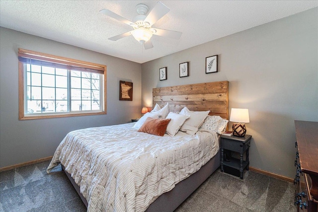 bedroom featuring a ceiling fan, baseboards, a textured ceiling, and carpet flooring