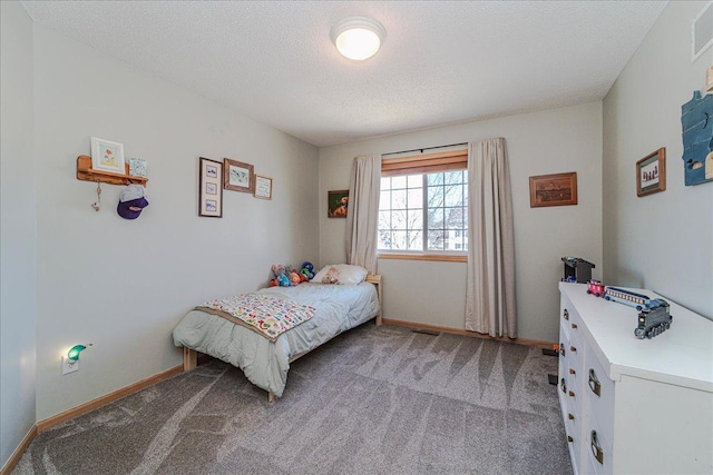 carpeted bedroom featuring visible vents, baseboards, and a textured ceiling