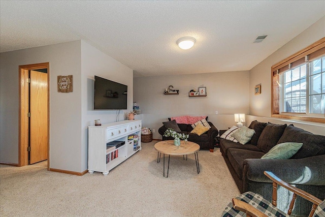 living room featuring visible vents, light carpet, a textured ceiling, and baseboards