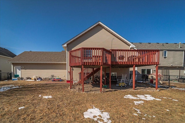 rear view of house with stairway, a wooden deck, and fence