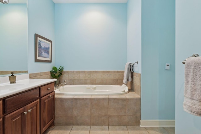 bathroom with vanity, tile patterned floors, and a bath