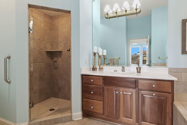 bathroom featuring tile patterned flooring, a stall shower, and vanity