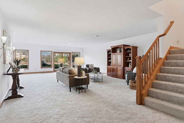 living area with light carpet, stairway, and baseboards