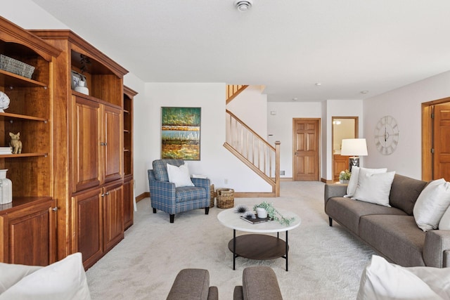 living area with light colored carpet, stairs, and baseboards