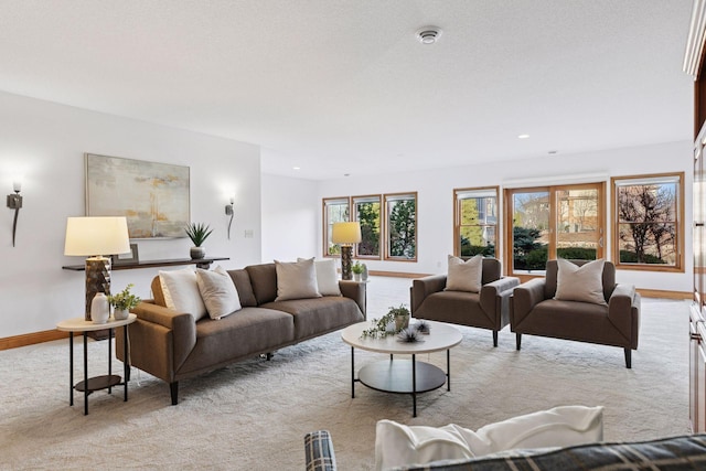 living area featuring recessed lighting, baseboards, and light carpet