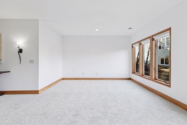 carpeted empty room featuring recessed lighting and baseboards