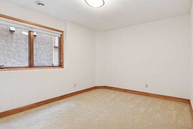 spare room with carpet flooring and baseboards