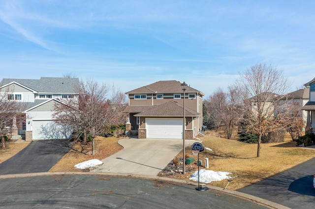 view of front facade featuring brick siding, concrete driveway, and a garage