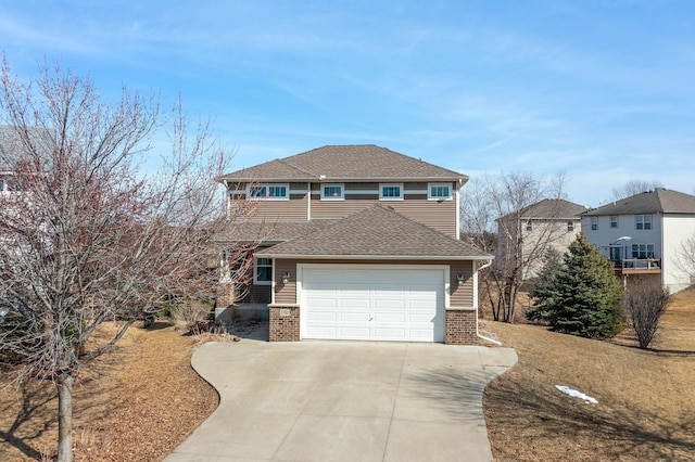 view of front of property featuring brick siding, driveway, an attached garage, and roof with shingles