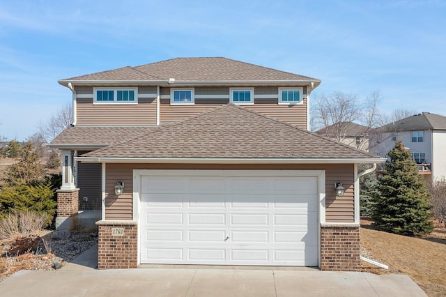 traditional-style home with brick siding, roof with shingles, concrete driveway, and an attached garage