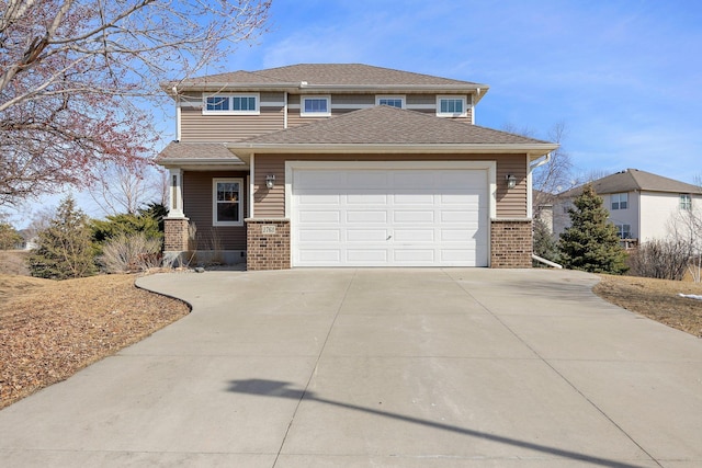 view of front of home featuring brick siding, concrete driveway, a garage, and roof with shingles