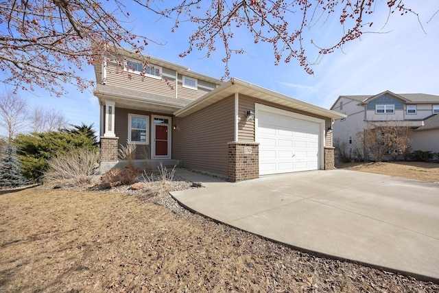 view of front of house with a garage, brick siding, and driveway