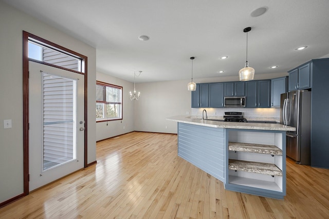 kitchen with light wood-type flooring, stainless steel appliances, and blue cabinetry