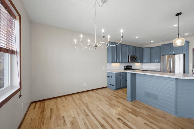 kitchen with blue cabinets, stainless steel appliances, visible vents, and a wealth of natural light